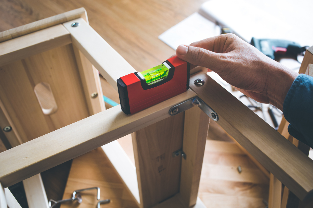 LEVELS tool on wooden furniture in workplace.