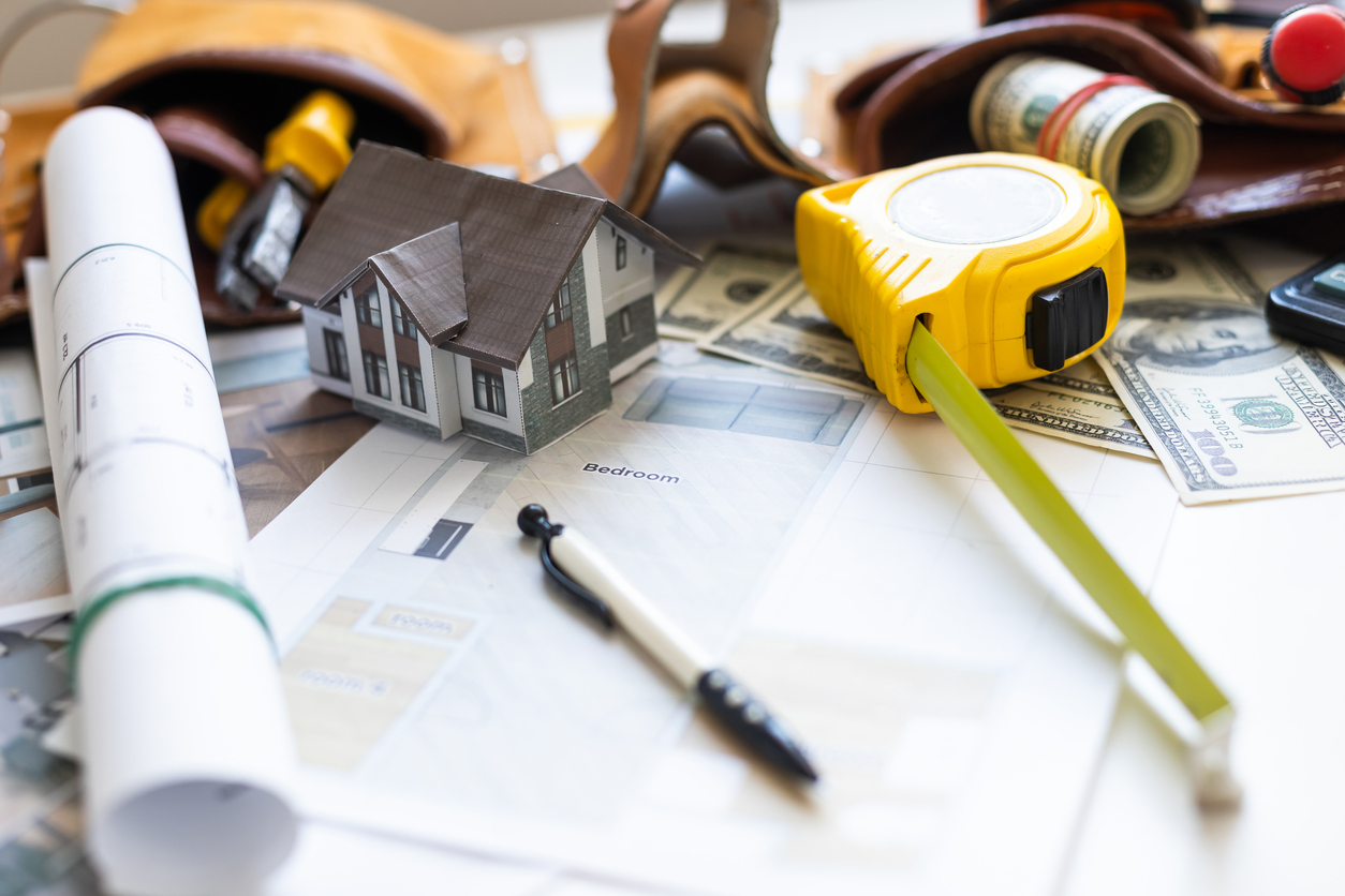 A model house on blueprints with keys to the new home Close up. 